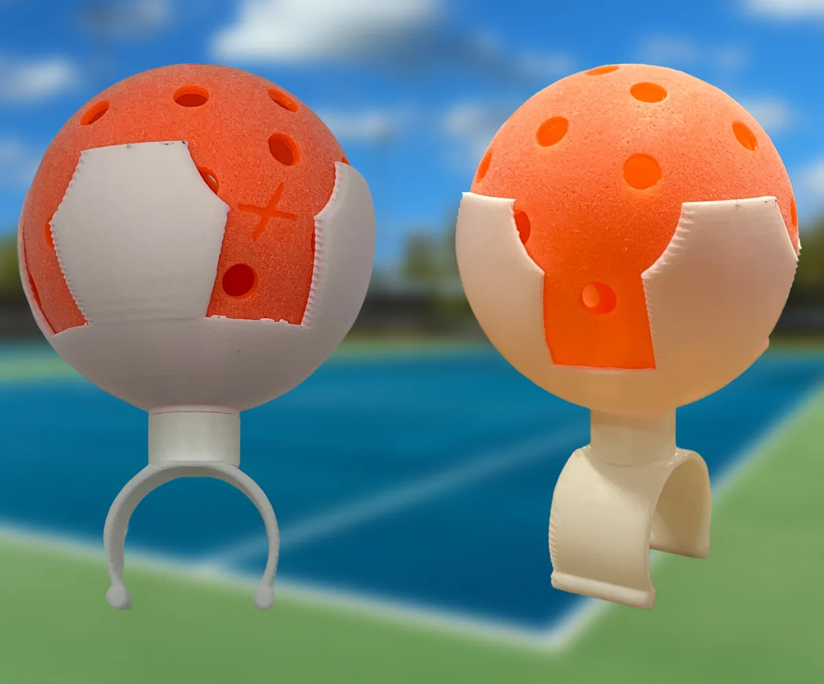 Two early PickleDock prototypes printed in white, each holding an orange ball